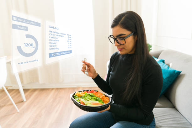 Hispanic woman wearing ar glasses checking calories and nutritional information of a fresh salad using augmented reality technology