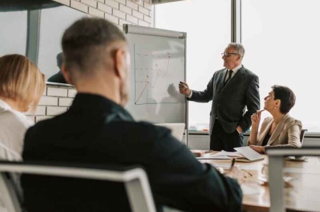 Business executive presenting governance strategy charts during a corporate board meeting.