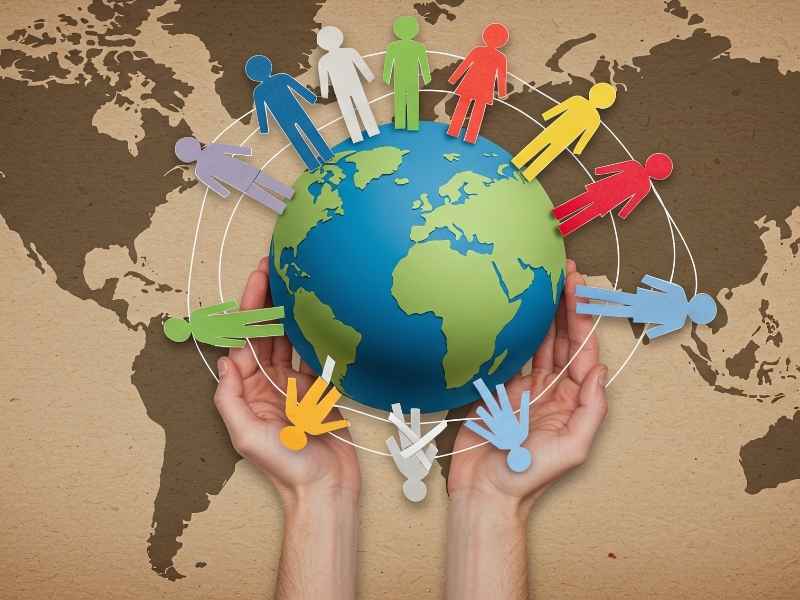 Illustration of diverse human figures surrounding a globe, representing global ESG standards, international reporting alignment, and cross-border compliance.