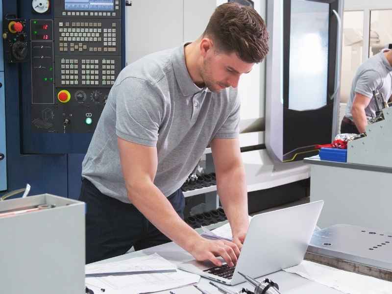 Worker using advanced industrial technology to improve productivity and competitiveness, highlighting the role of modernization in Building Investor Confidence.
