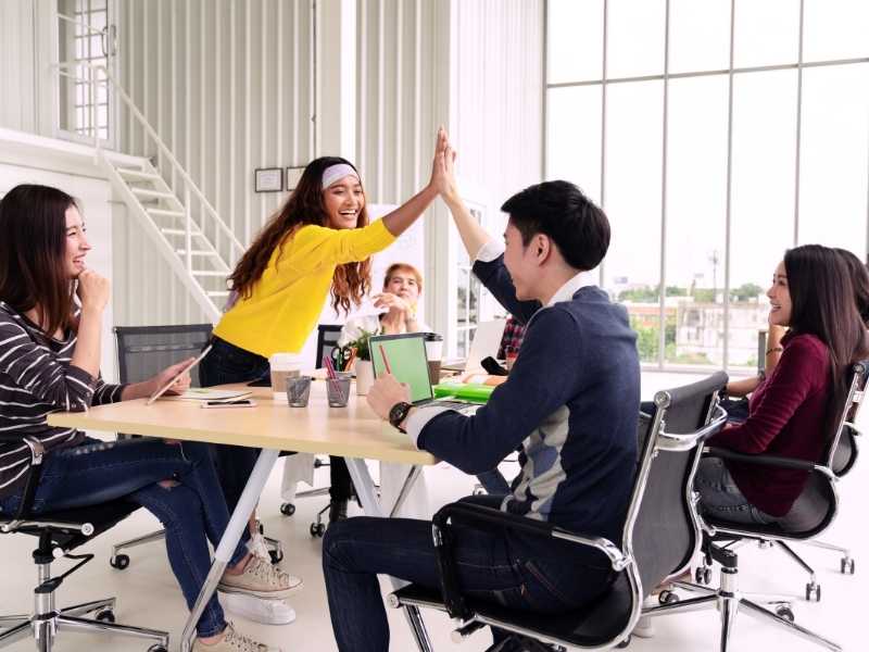Team members celebrating a win in an office, showing positive communication and reliable service.