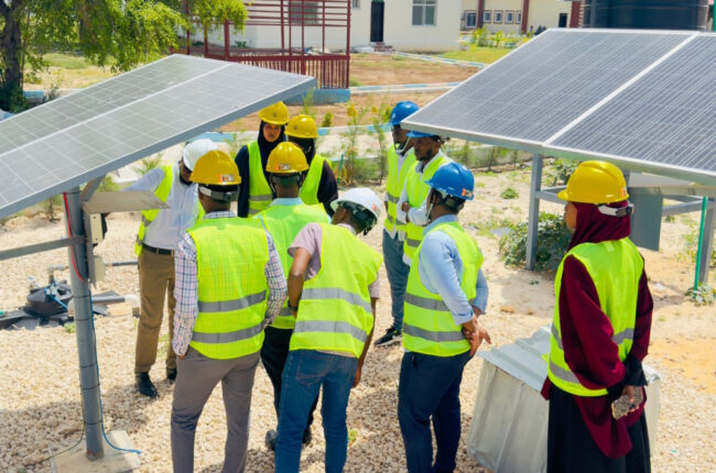 Workers receiving technical training for renewable energy jobs as part of a just transition strategy